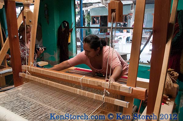 Teresa demonstrates weaving on one of her looms